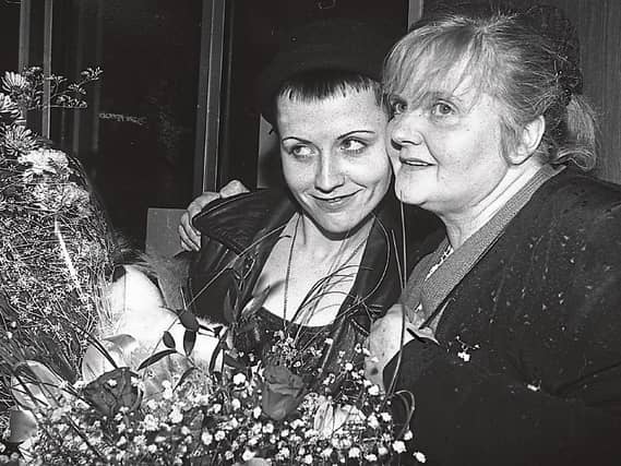 Eileen O’Riordan with her late daughter Dolores in Shannon Airport in 1991. Below, the shrine in Ballybricken church dedicated to the star Pictures: Limerick Leader