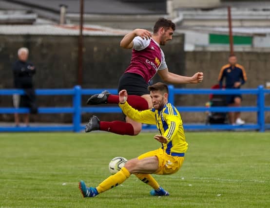 Jeffrey Judge, of Fairview Rgs, wins the ball from Athenry's Morgan Leggett during the FAI Senior Cup tie at The Fairgreen Picture: Kieran Ryan-Benson