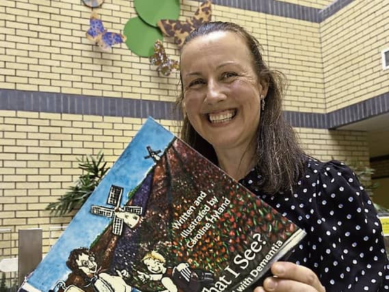 Author and illustrator Caroline Hyland with the front cover of the book