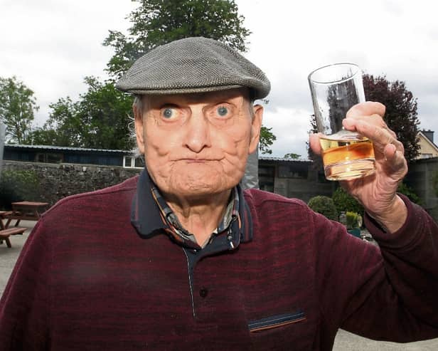 Lovely! Ballybrown man Gilbert Smith, who turns 97 next week, enjoys his first glass of Paddy’s whiskey in Punch’s Bar, Patrickswell since March 2020  | PICTURE: BRENDAN GLEESON