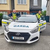 Noah Quish, Monaleen, shows Garda James Keehan and Garda David Stapleton his patrol car and then tries their one out for size