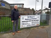 Sinn Fein councillor John Costelloe pictured at the gate of St Mary’s National School, where there are fears for teaching jobs