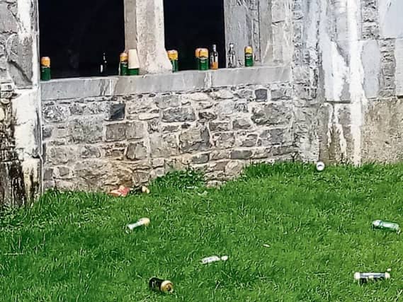 Used bottles and cans discarded on a ledge at the Abbey in Kilmallock