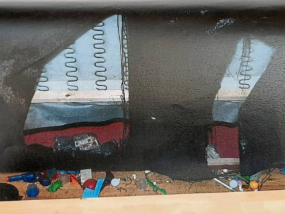 A significant quantity of cash and drugs were found hidden in the couch (pictured above)