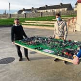 The town that children built: Teachers, Tommy Greaney, Eoin Quane and Liam O’Donoghue helping move a real example of the building blocks of learning