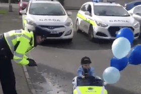 Licence and registration, please: Noah looks the part in his garda car