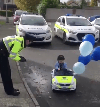 Licence and registration, please: Noah looks the part in his garda car