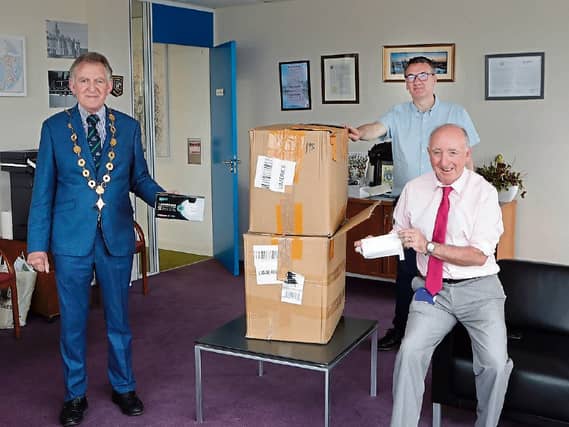 Mayor Michael Sheehan is photographed above with Paul Moore and John Doyle of the H&S PPE team with part of the consignment | PICTURE: LIAM BURKE/PRESS22