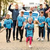 Limerick hurling boss John Kiely with players Will O'Donoguhe and Diarmaid Byrnes launch the fun run with a little help from young athletes