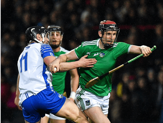 Limerick's David Dempsey attempts to break past Waterford's Pauric Mahony