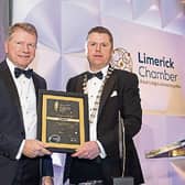 Hugh O'Donnell, left, receiving his award from Chamber president Eoin Ryan