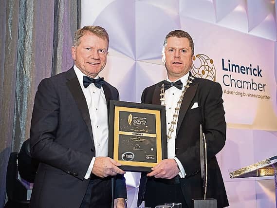 Hugh O'Donnell, left, receiving his award from Chamber president Eoin Ryan
