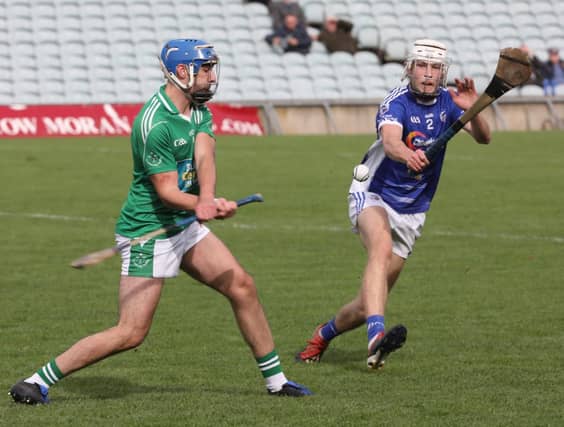 Marty Farrell of Blackrock strikes forward past Luke O'Keeffe of Kildimo-Pallaskenry