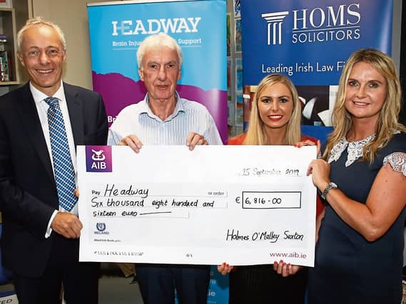 Robert Bourke and Sarah Falvey, Holmes O'Malley Sexton, presenting the donation to Kieran Loughran and Rella Galvin, Headway PICTURE: Adrian Butler