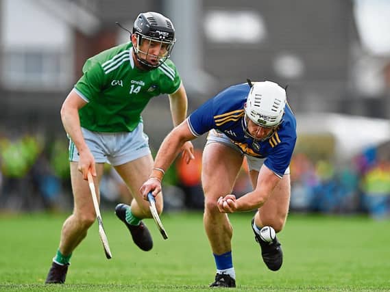 Constant pressure: Seán O'Brien of Tipperary in action against Graeme Mulcahy of Limerick during the Munster GAA Hurling Senior Championship Final