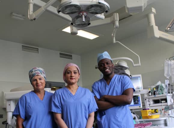 Maura Tully, CNM2, Ms Uzma Mahmood, lead robotic gynaecologist, and Roland Pika, staff nurse