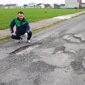 Election candidate Dean Quinn pointing out the poor state of this road in Moyross