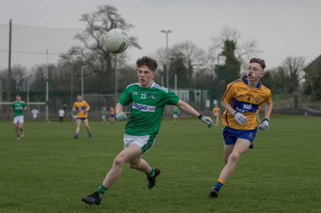 Limerick's Conor Galvin looks to win possession ahead of Clare's Ciaran McMahon in Newcastle West