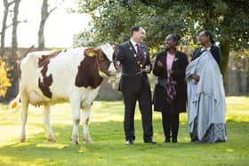 Mayor James Collins with a Bothar cow in Limerick with Chantal Mutesi Rwandan Egwyge Roussard PICTURE: SEAN CURTIN/TRUE MEDIA