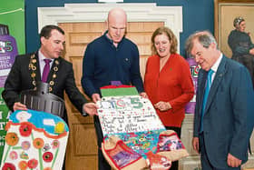 Mayor of Limerick City and County, Cllr James Collins, Paul O'Connell, Helen O'Donnell and JP McManus look closely at a poster design at the 'Design a TLC Bottle' prizegiving |PICTURE: Diarmuid Greene