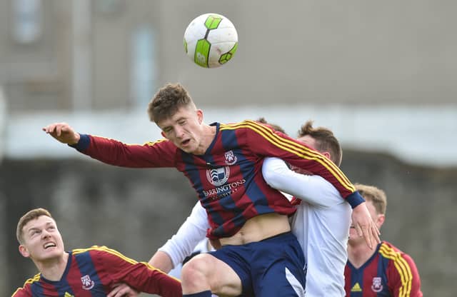 Sean McSweeney, of UL, wins this header against Garan Manley, of UCC, in their Rustlers Collingwood Cup final at the Markets Field this Wednesday