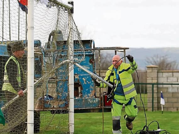 The show must go on: Nothing stands in the way of Kileedy GAA hosting their All-Ireland Junior B series. Here Seanie O'Brien is pictured welding a stanchion back onto the goal in some last minute prep