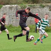 Paul Sheahan, Glin Rovers, touches the ball away from Michael Crehan, Sporting Ennistymon, before going on to score his side's second goal during their clash in the Junior Cup Round 2 clash in Glin