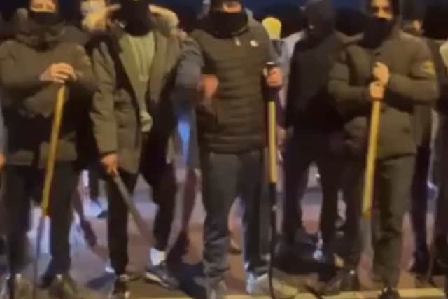 A group of men armed with weapons are standing on the M20 flyover in Dooradoyle (pictured below) while motorists are delayed behind them.