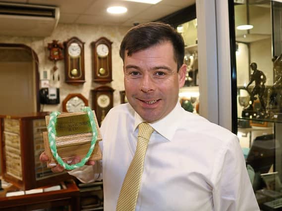 Robbie Kenneally holds a special box containing his father’s ashes at the family business, JJ Kenneally’s on Wickham Street Picture: Michael Cowhey