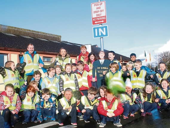 Junior infants from Lisnagry NS and teachers Patrick O’Neill, Sheena McDonald, Maura Barry with one of their new road safety signs Picture: Michael Cowhey