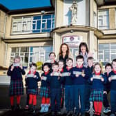 Celia Holman Lee and principal Deirdre Cusack with pupils of the Salesian Primary School Picture: Keith Wiseman