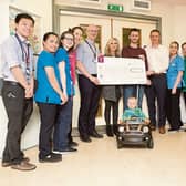 Team Evan Jones: Paddy, Marisa, Ben Jones and Mike Coffey present a cheque to Dr Cormac Owens and the medical team in the oncology ward