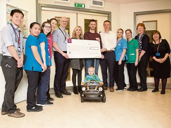 Team Evan Jones: Paddy, Marisa, Ben Jones and Mike Coffey present a cheque to Dr Cormac Owens and the medical team in the oncology ward