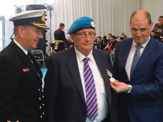 Tadhg Quinn receiving his Bonn Jadotville from Minister of State with responsibility for Defence, Paul Kehoe and Chief of Staff of the Defence Forces, Vice Admiral Mark Mellett