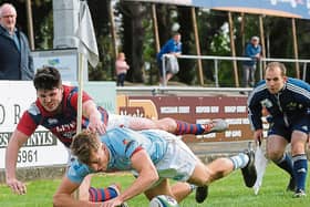 Garryowen's Liam Coombes scores his team's first try despite the efforts of Max McFarland, Clontarf in their Ulster Bank League game at Dooradoyle