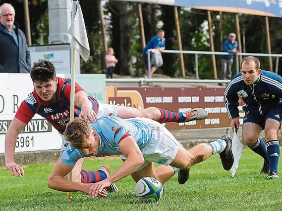 Garryowen's Liam Coombes scores his team's first try despite the efforts of Max McFarland, Clontarf in their Ulster Bank League game at Dooradoyle
