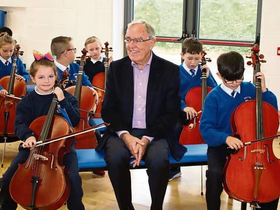 Honorary Doctorate recipient and Irish Chamber Orchestra chair Michael Buckley with Le Chéile pupils Picture: Michael Cowhey