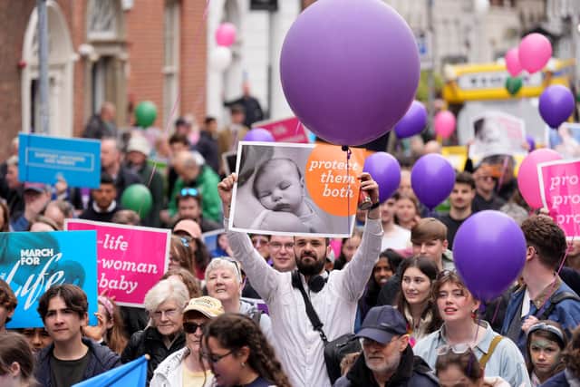 March For Life demonstrators carried a banner reading “pro-woman, pro-baby, pro-life”, and signs displaying “abortion betrays women” and “real debate not groupthink”.