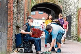Popular local busker Tom McNamara playing in one of his regular spots in the city centre