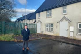 Boarded up: Cllr Dan McSweeney, pictured outside the homes in Patrickswell which have been out of use for an extended period