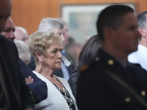 Anne McCabe sitting during mass