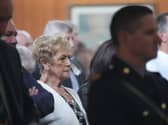 Anne McCabe sitting during mass