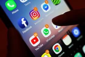 A finger pressing on a mobile phone screen