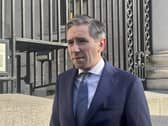 Head and shoulders photo of Simon Harris speaking outside
