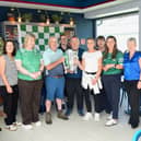The team of staff at Carebright Bruff pictured with Limerick hurler Sean Finn and the Mick Mackey Cup at the launch of Kilmallock to Kilimanjaro