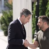 Simon Harris shakes hands with Ukrainian President Volodymyr Zelensky