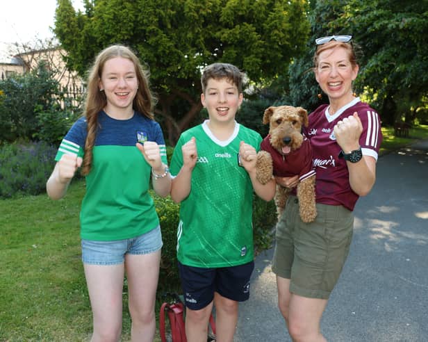 Cllr Maria Donoghue and Poppy the dog cheering on Galway with her children, Alex and Ben Donoghue Corbett cheering on Limerick |PICTURE: Adrian Butler