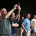 Limerick manager John Kiely takes a video on his smartphone of the supporters at the homecoming celebrations of the All-Ireland Senior Hurling Champions at Pery Square