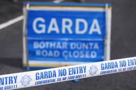 Garda tape and road closed sign