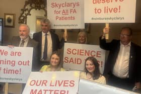 People with posters campaigning about the drug Skyclarys